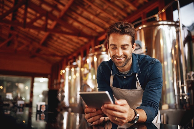 male business owner looking at tablet