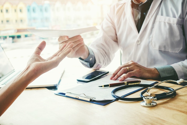  doctor and patient going over paperwork