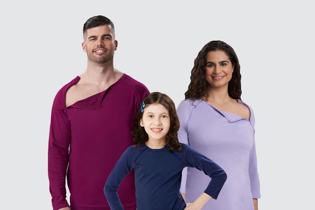 Three models wearing tops by Care+Wear that open for chest port access.