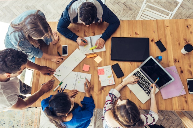 group of coworkers sitting in a meeting