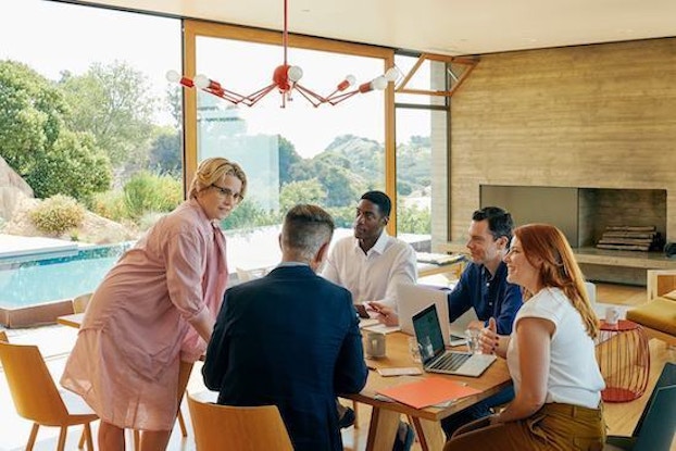coworkers having a meeting in a house