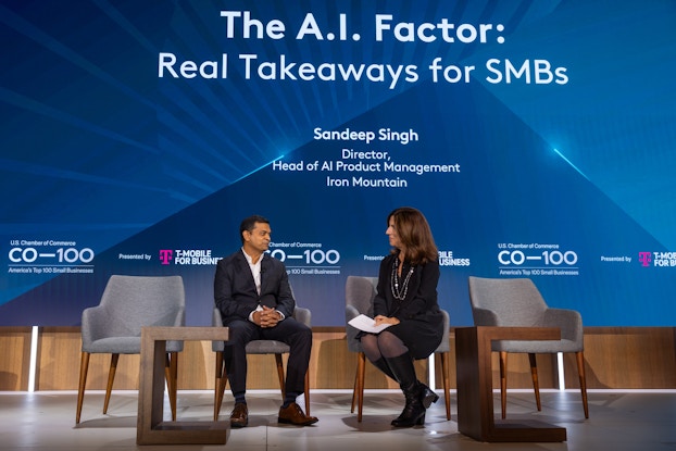 The U.S. Chamber's Kristen DelGuzzi talks with Sandeep Singh, Director and Head of AI Product Management at Iron Mountain, on stage at an event.
