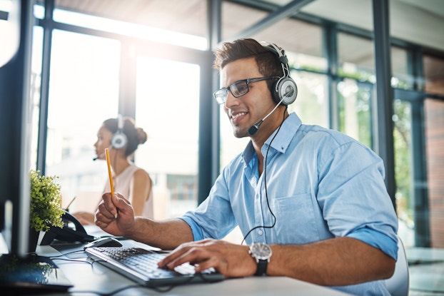 male employee on headset at work