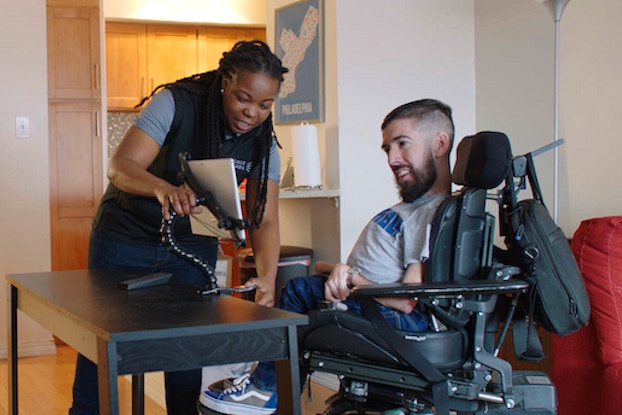 Man in wheelchair looking at computer screen