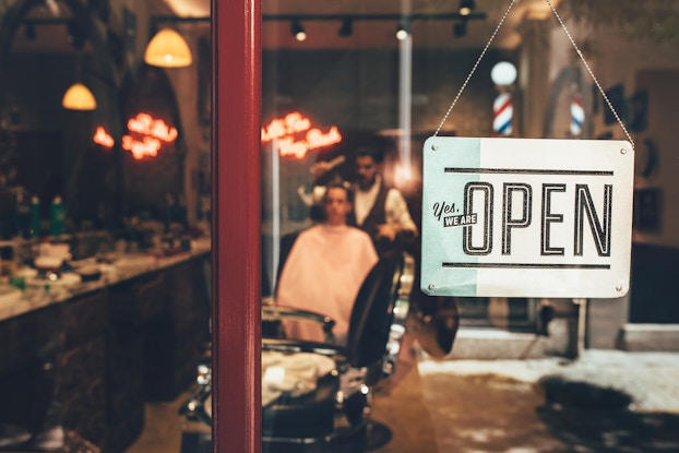 open sign in barber shop window