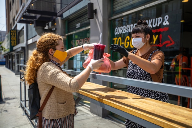 woman picking up curbside takeout