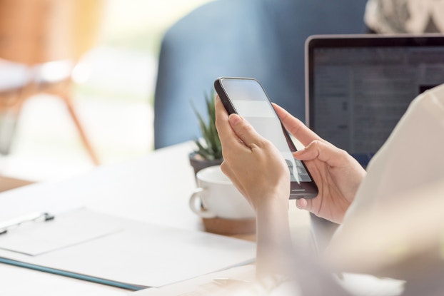 person sitting at desk on phone