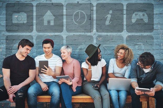 Young people socializing and looking at tablet and laptop