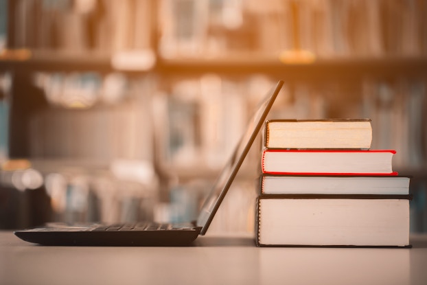 laptop on table with books