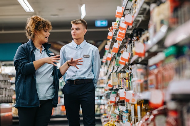 Supermarket manager training to a new employee