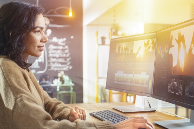  woman creating and editing a video on computer