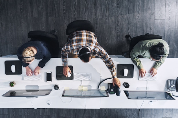  Overhead shot of employees at desk