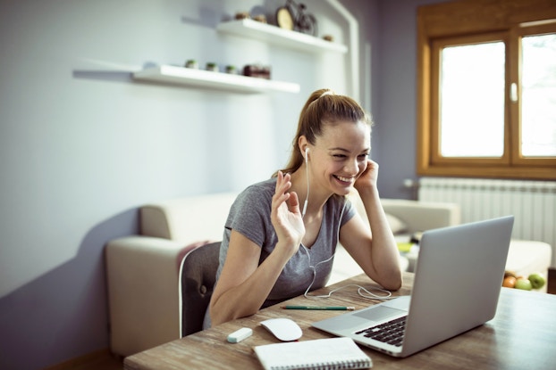  woman at home working remotely on laptop