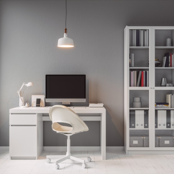 Modern home office with white furniture.