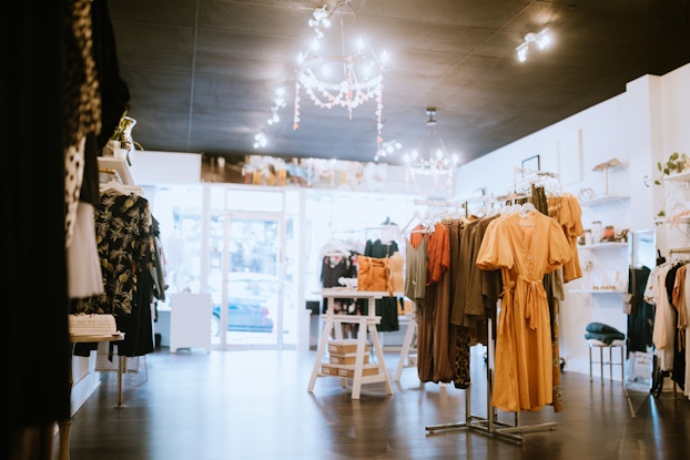 Interior of a boutique shop with clothing and accessories.