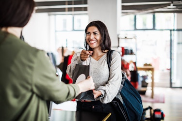 Happy customer making a purchase in a shop.