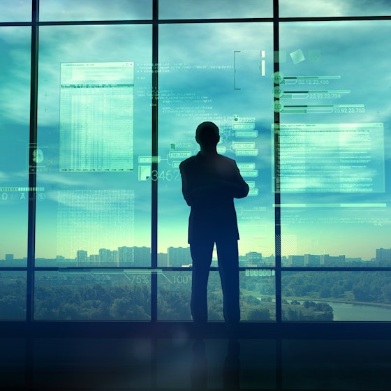  man looking out window with coding text in background 