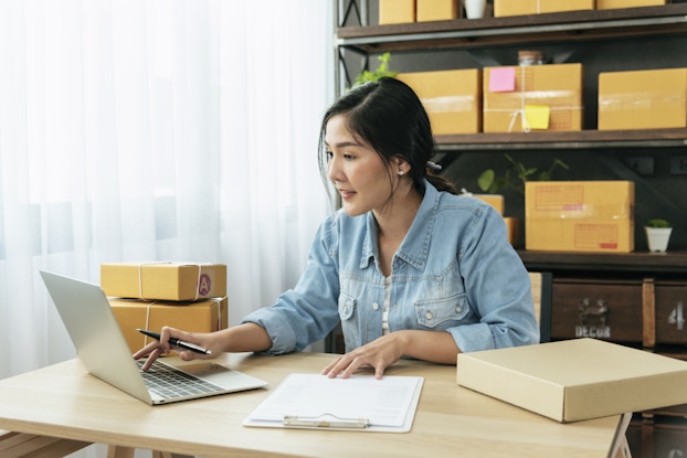Woman working inside her office on her laptop.
