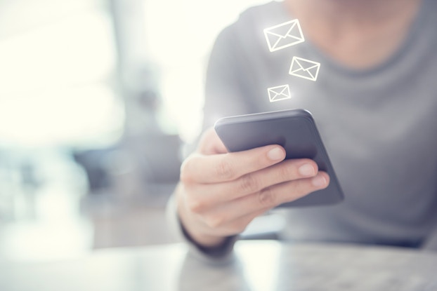  woman checking email on smartphone