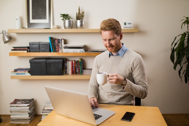  Man with coffee at laptop