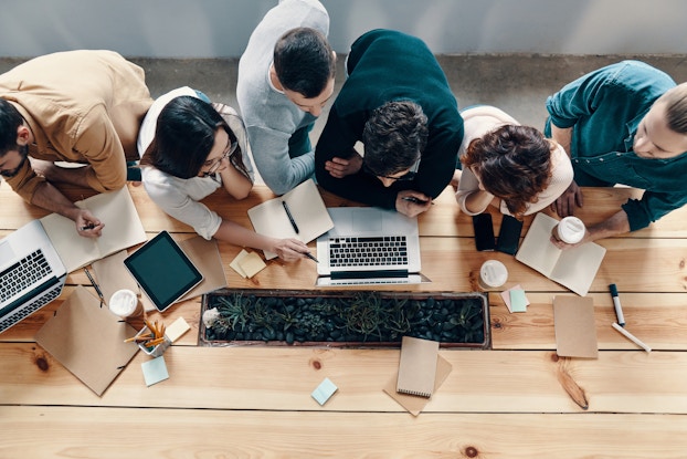  team working together on laptops