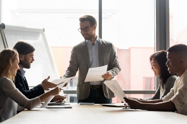 group of employees at table in a meeting