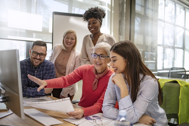 Senior designer demonstrates skills to younger employees
