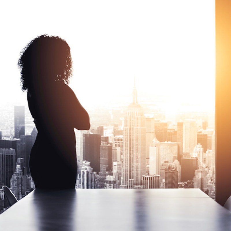 Woman staring out window at Empire State Building