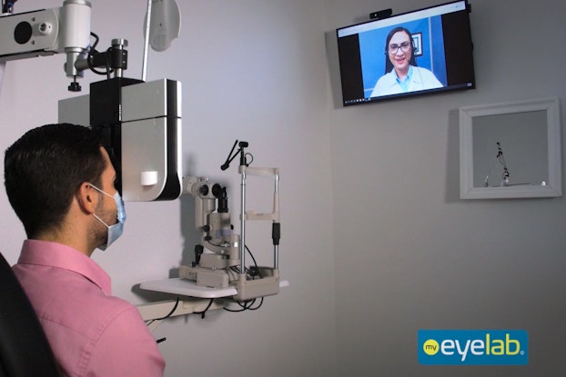 patient inside an eyelab location visiting virtually with a doctor for an eyeglass prescription.