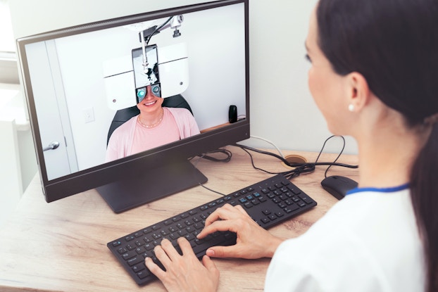 `eye doctor having a virtual visit with a patient for an eyeglass prescription