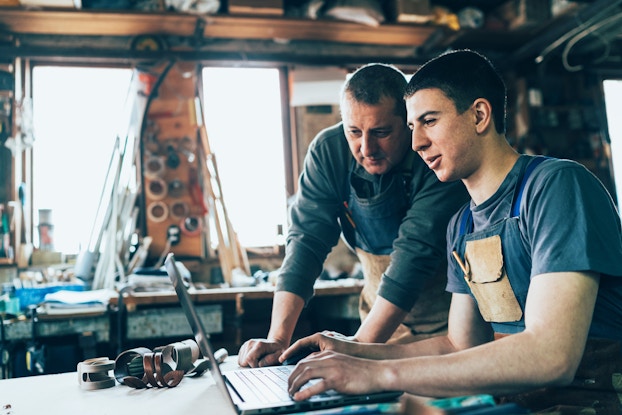  two men working together in carpentry workshop