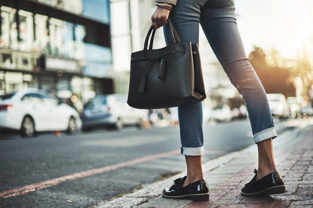 woman walking with purse on street