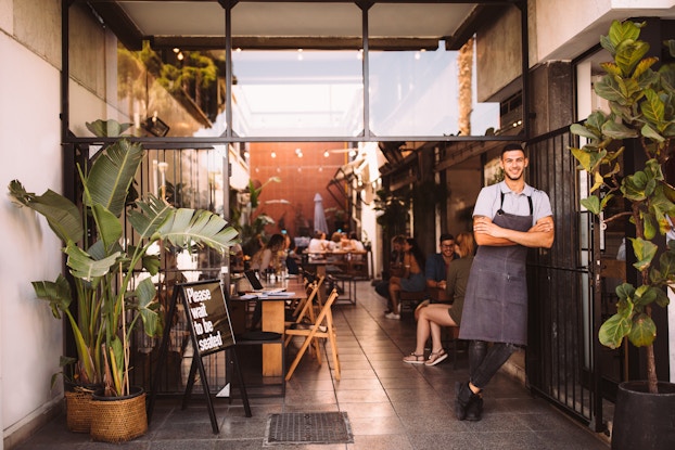  man standing at the entrance of a business