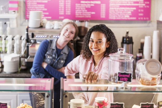 Workers behind restaurant counter