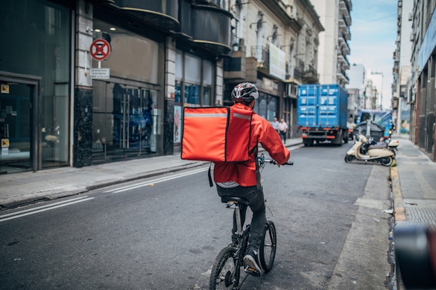  man delivering food on bicycle