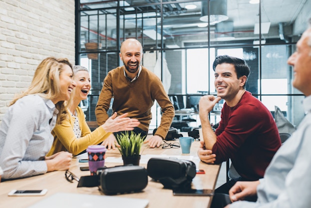  coworkers laughing in a meeting