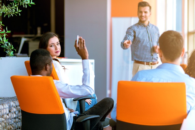  Man raising hand in training class