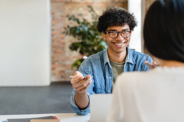 Smiling person in an interview with a potential employer.