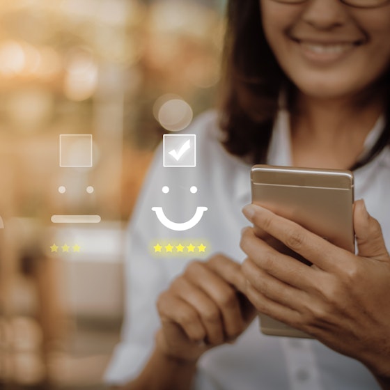 woman holding phone with positive customer service image