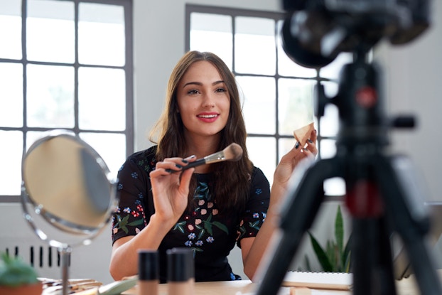 female influencer recording makeup tutorial