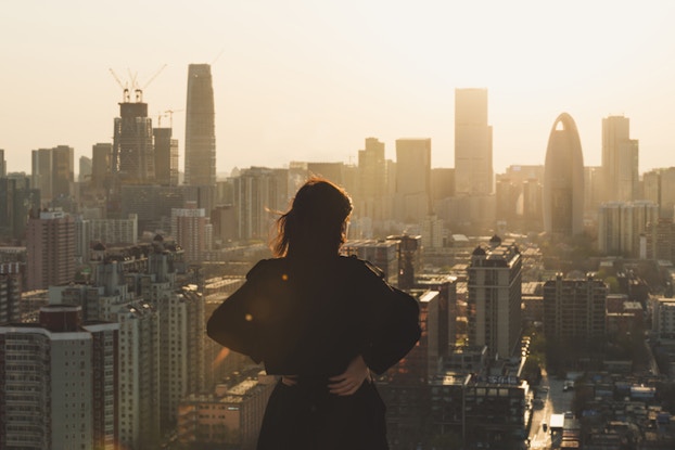 Woman staring at city skyline