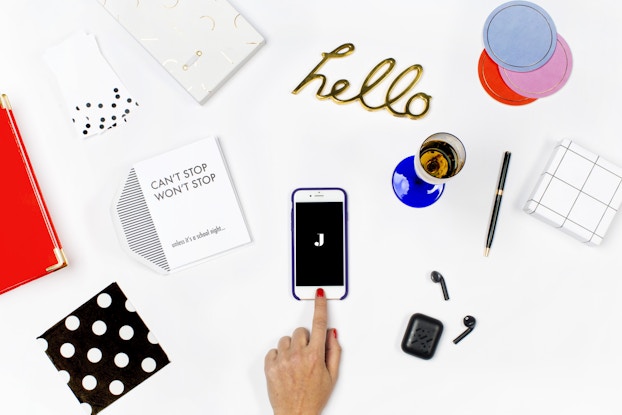 jetblack's branding spread on a white desk with phone