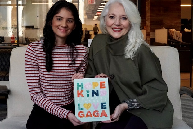  Cynthia Germanotta (right), president and co-founder, and Aysha Mahmood, editor, both of the Born This Way Foundation, sitting down both holding a book.