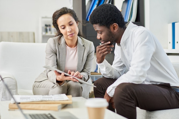  woman going over paperwork with a man