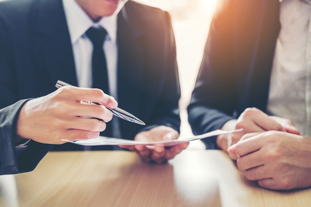 two men signing a contract