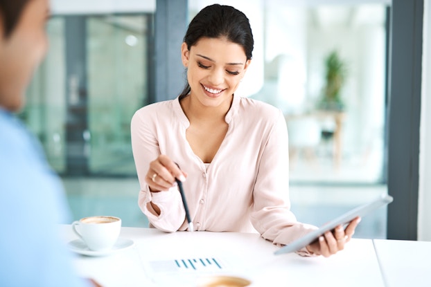  woman going over marketing plans with tablet