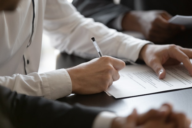 professional person signing contract