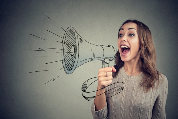 Woman yelling through bullhorn