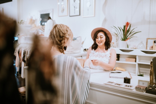 woman paying for her purchase at a boutique