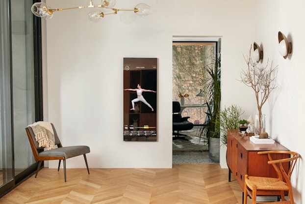 Fitness device Mirror hanging on wall inside a home.
